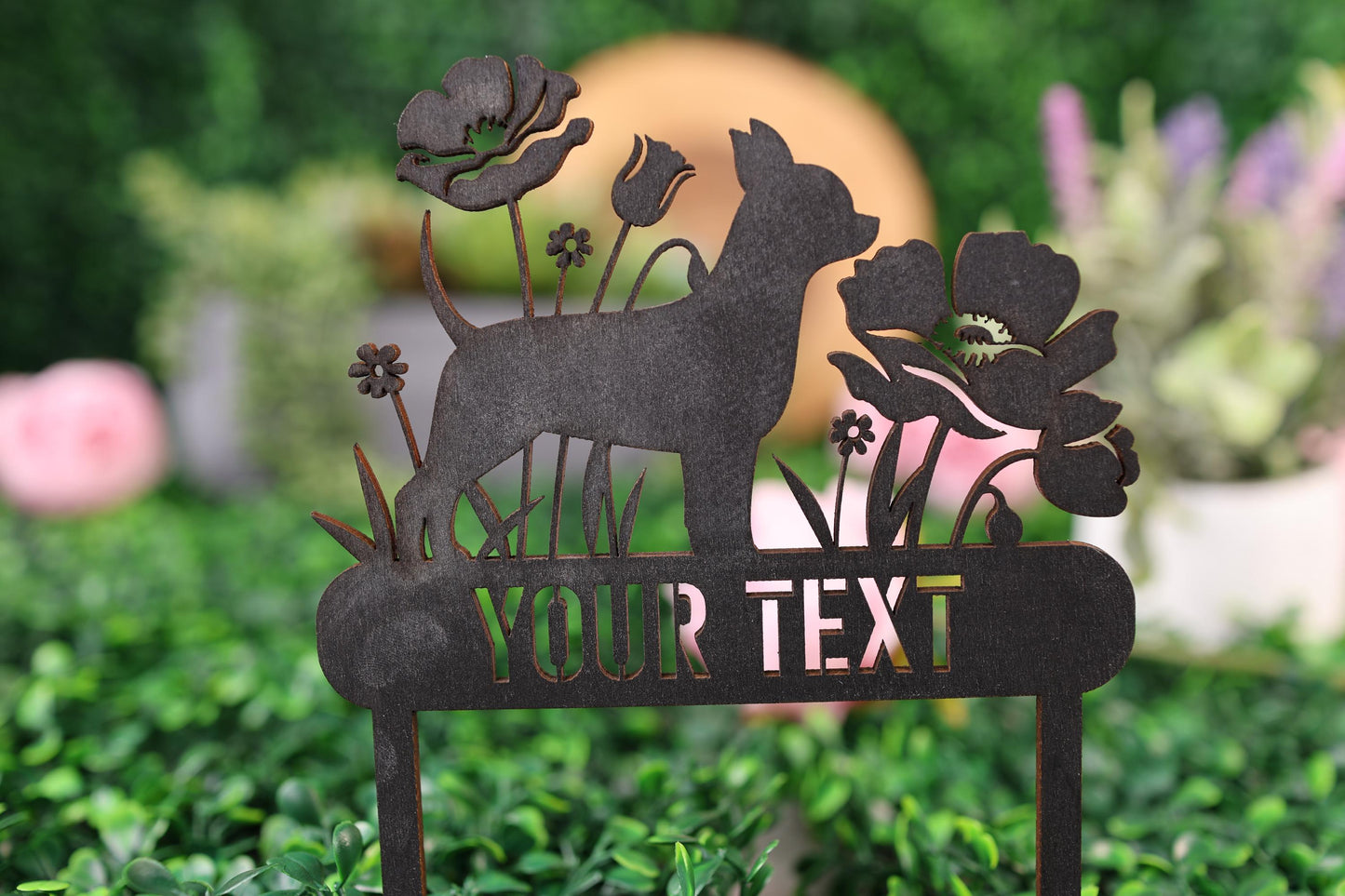 a metal sign with a deer and flowers on it