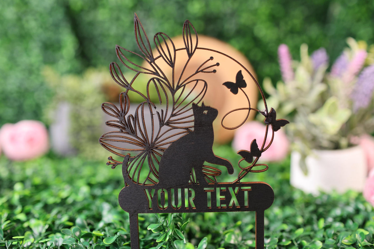 a cat is sitting on a sign in the grass