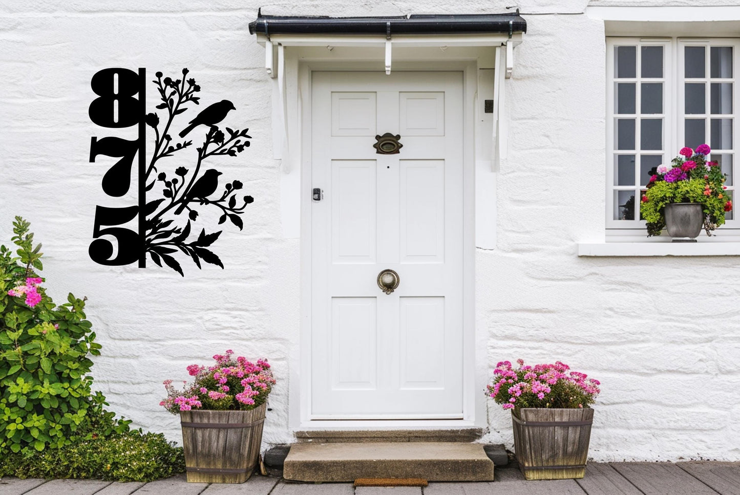 a white door sitting next to two flower pots