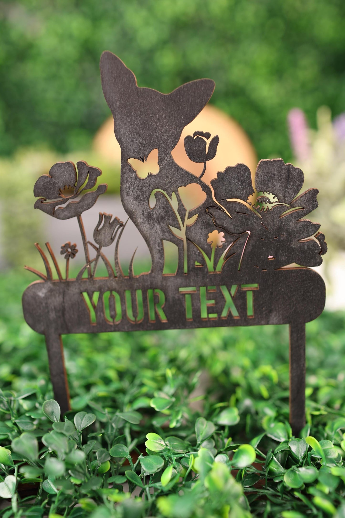 a close up of a metal sign on a tree