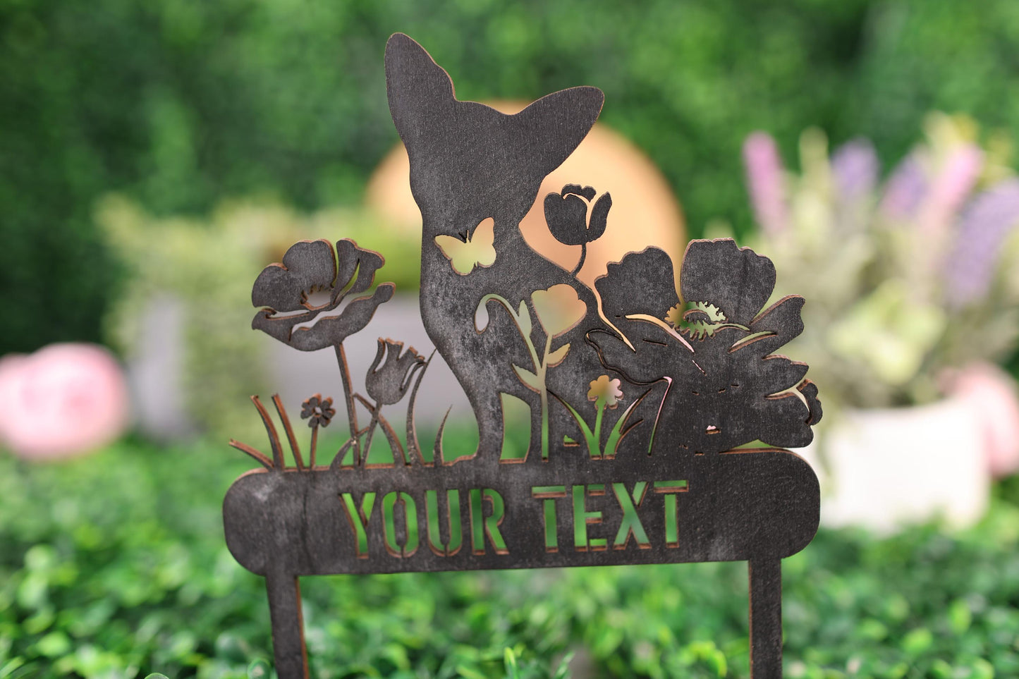 a metal sign with a cat and flowers on it