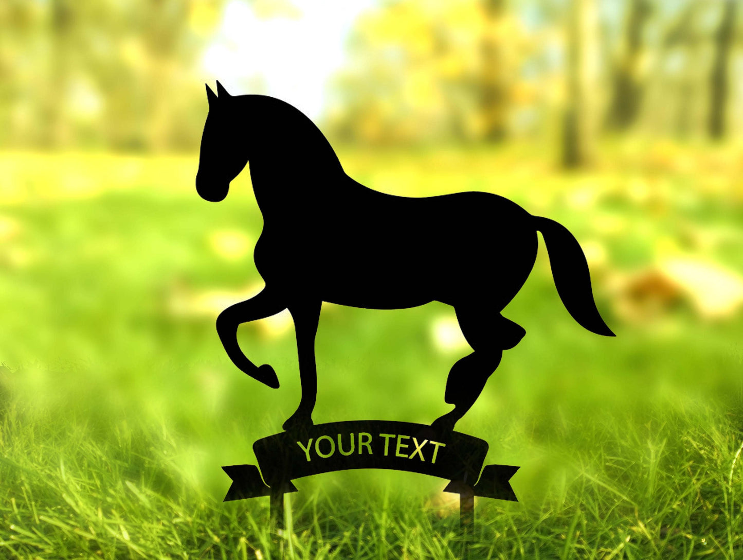 a silhouette of a horse standing on top of a lush green field