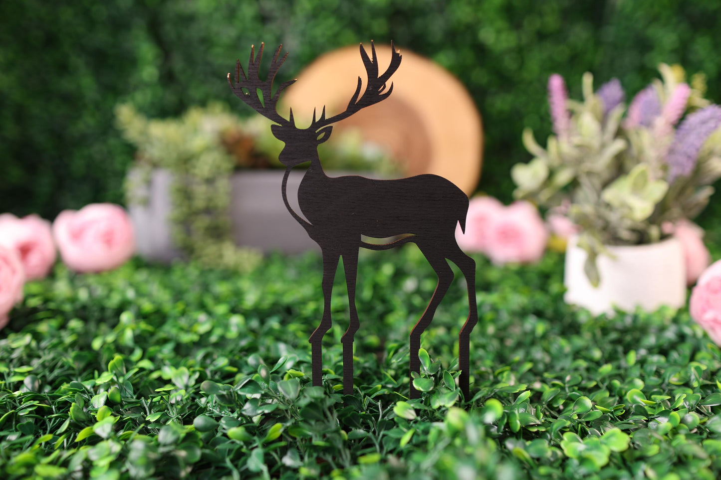 a paper cut of a deer standing in a field of flowers