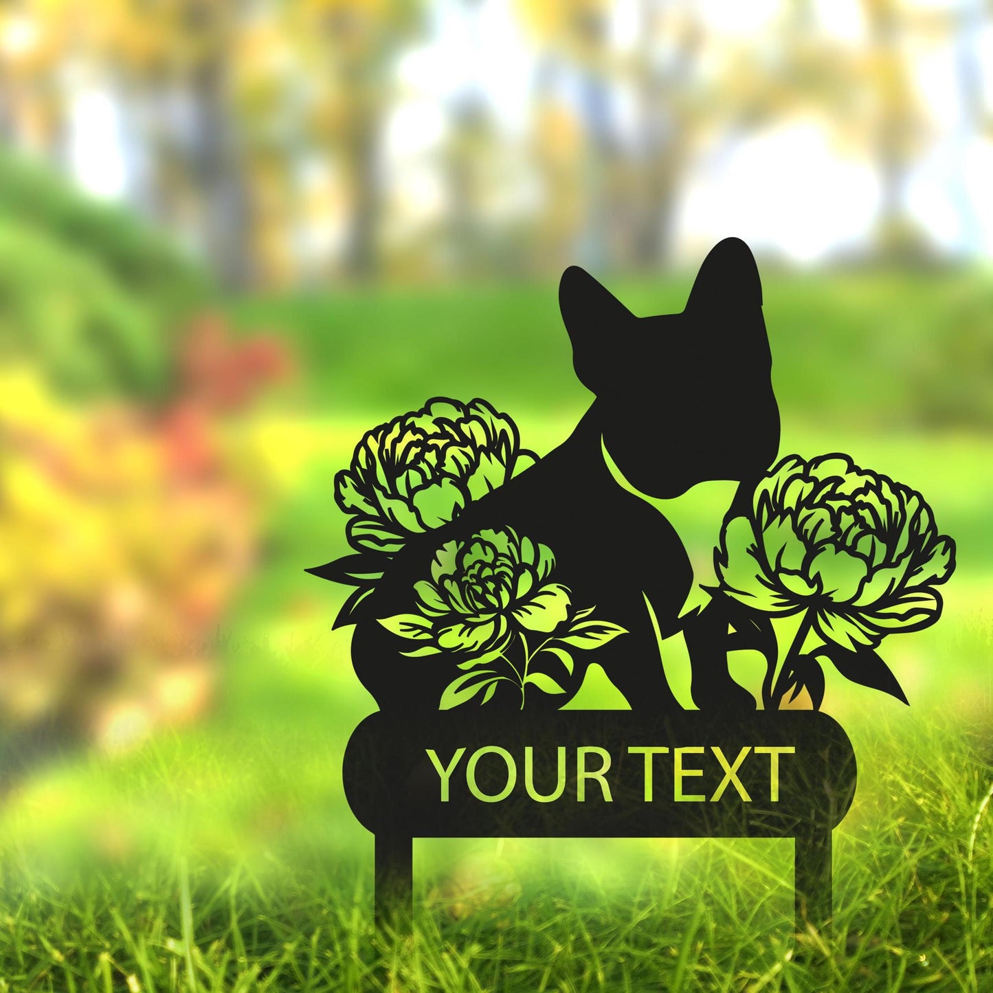 a silhouette of a dog sitting on a bench with flowers