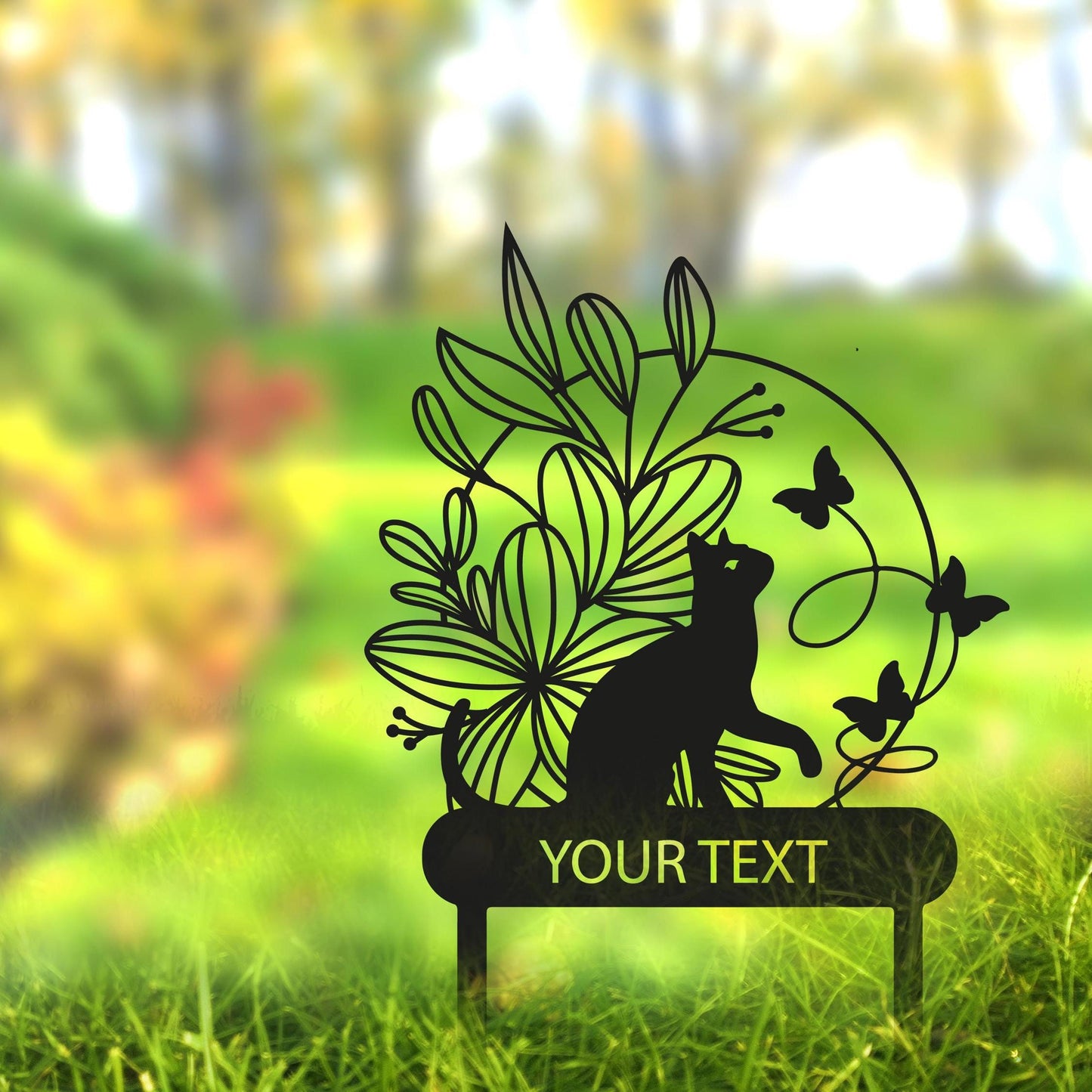 a sign that is in the grass with a cat on it