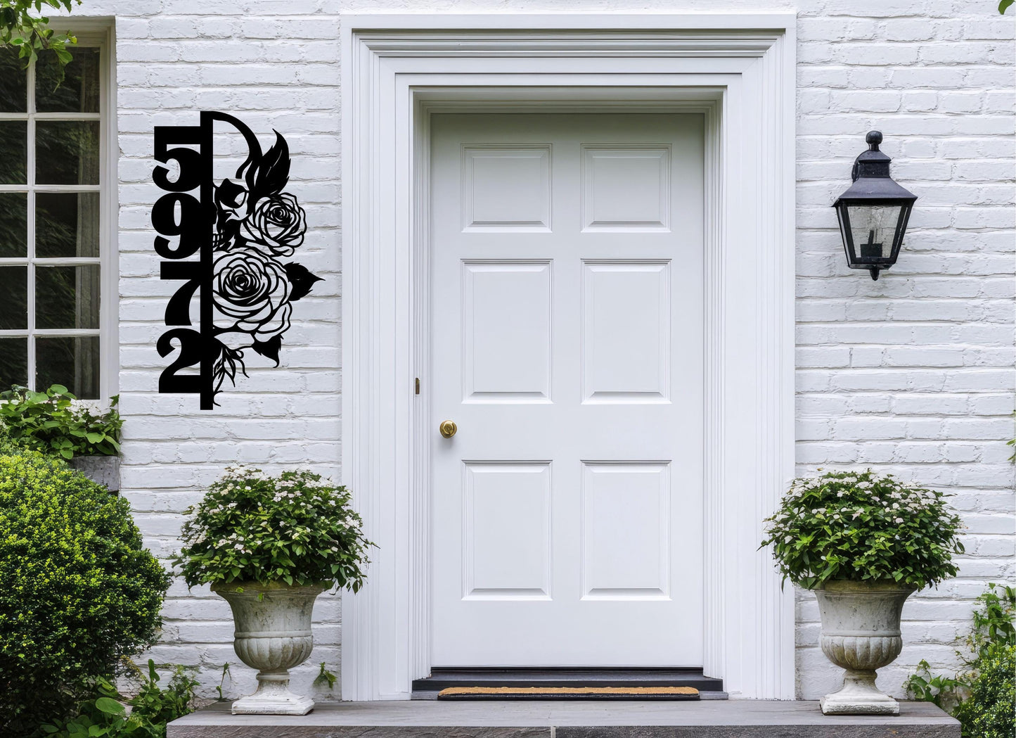 a white front door with a black floral design on it