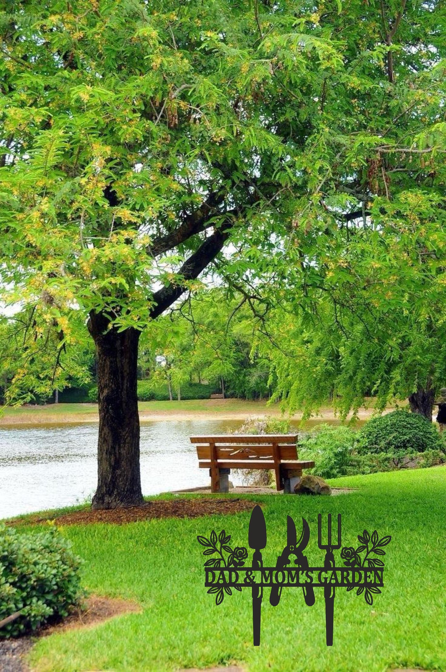 a park bench under a tree next to a lake