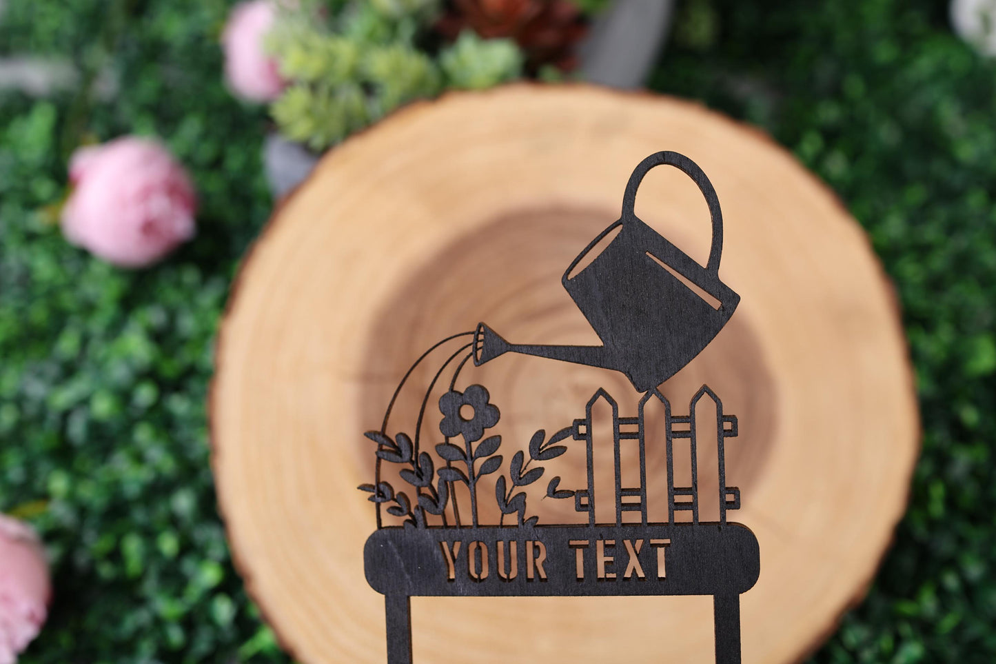 a wooden sign with a watering can on it