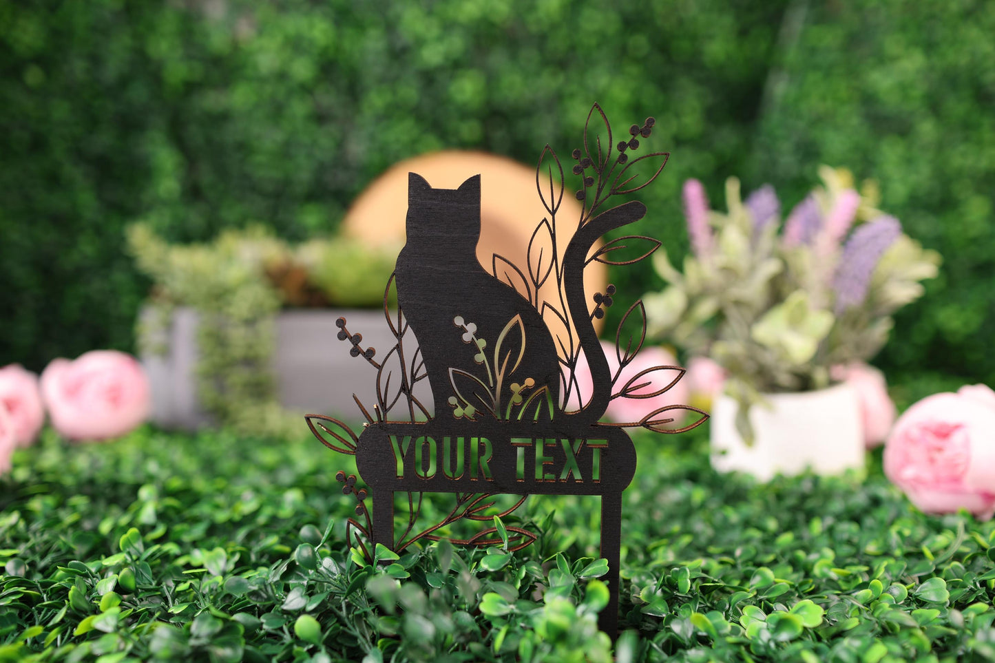 a black cat sitting on top of a wooden sign