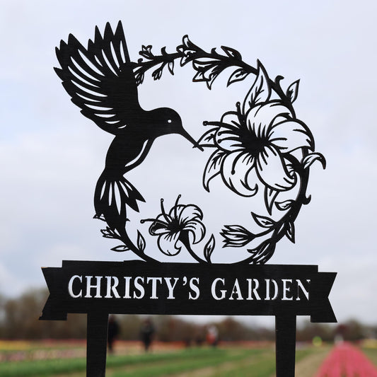 a sign with a bird and flowers on it