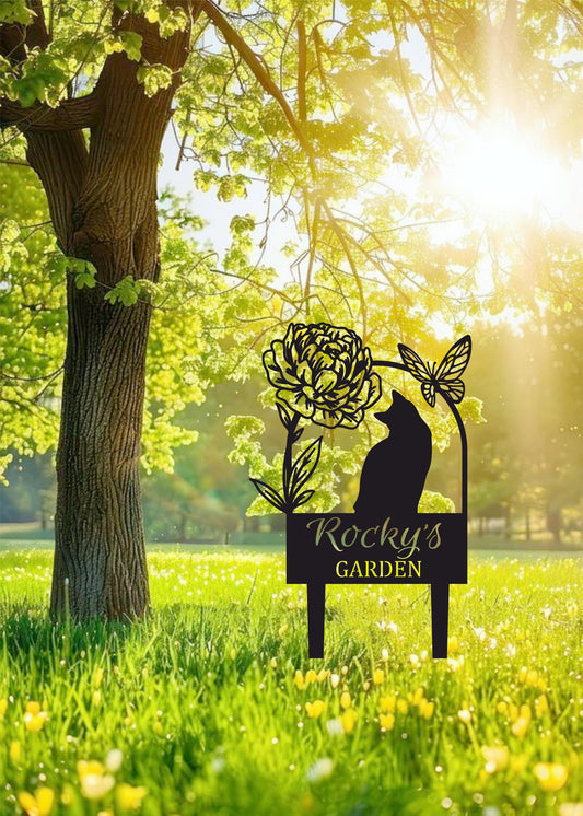 a cat sitting on top of a sign in the grass