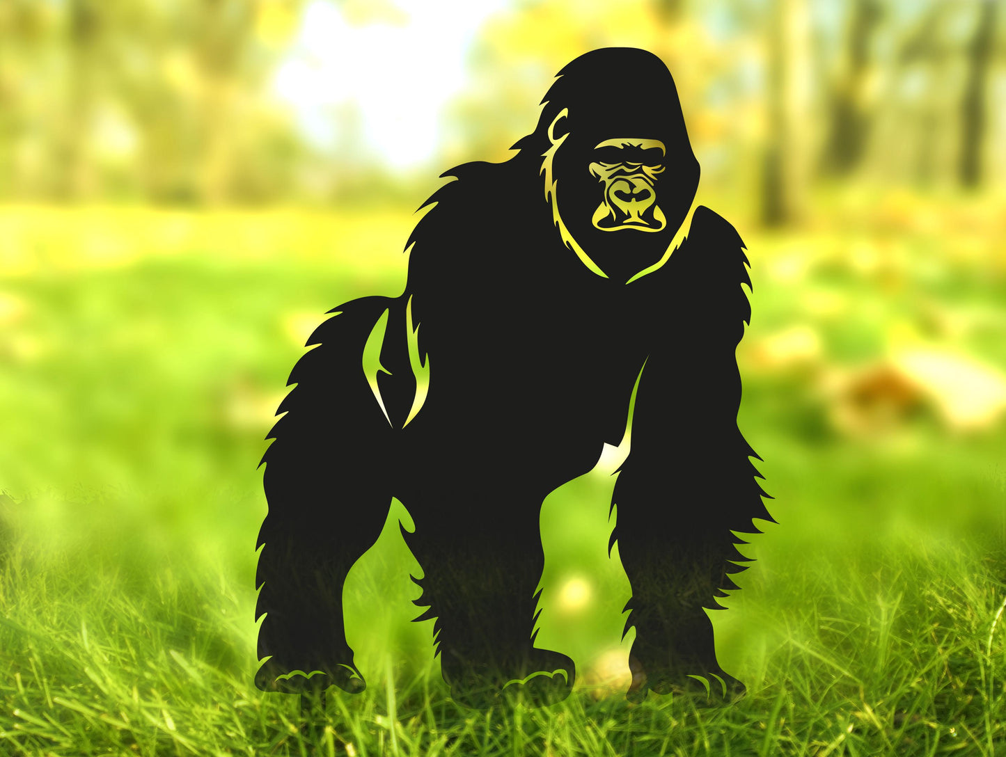 a gorilla standing in a field of green grass