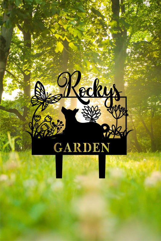 a garden sign in the middle of a grassy area
