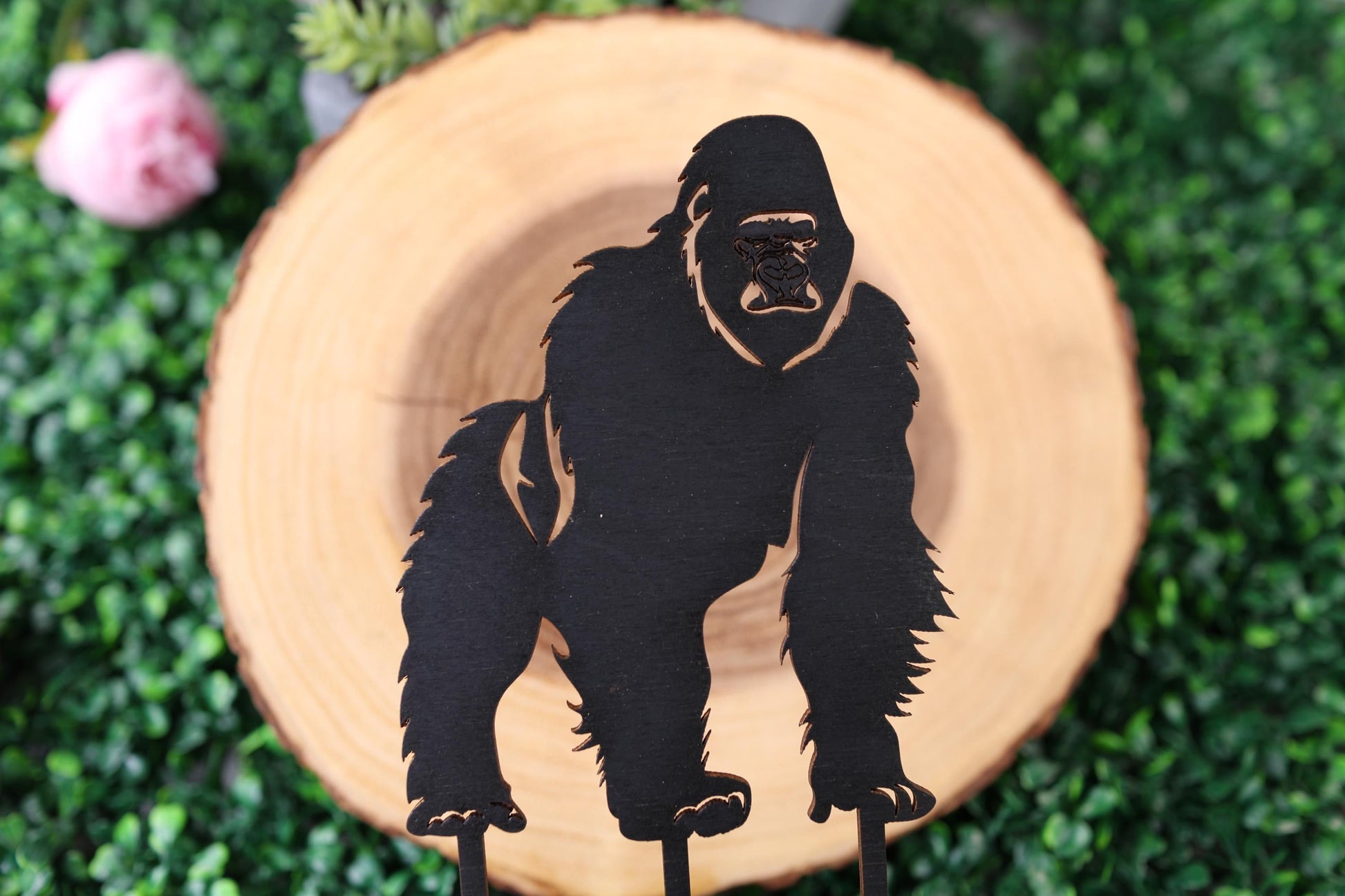 a paper cut out of a gorilla standing on a stick