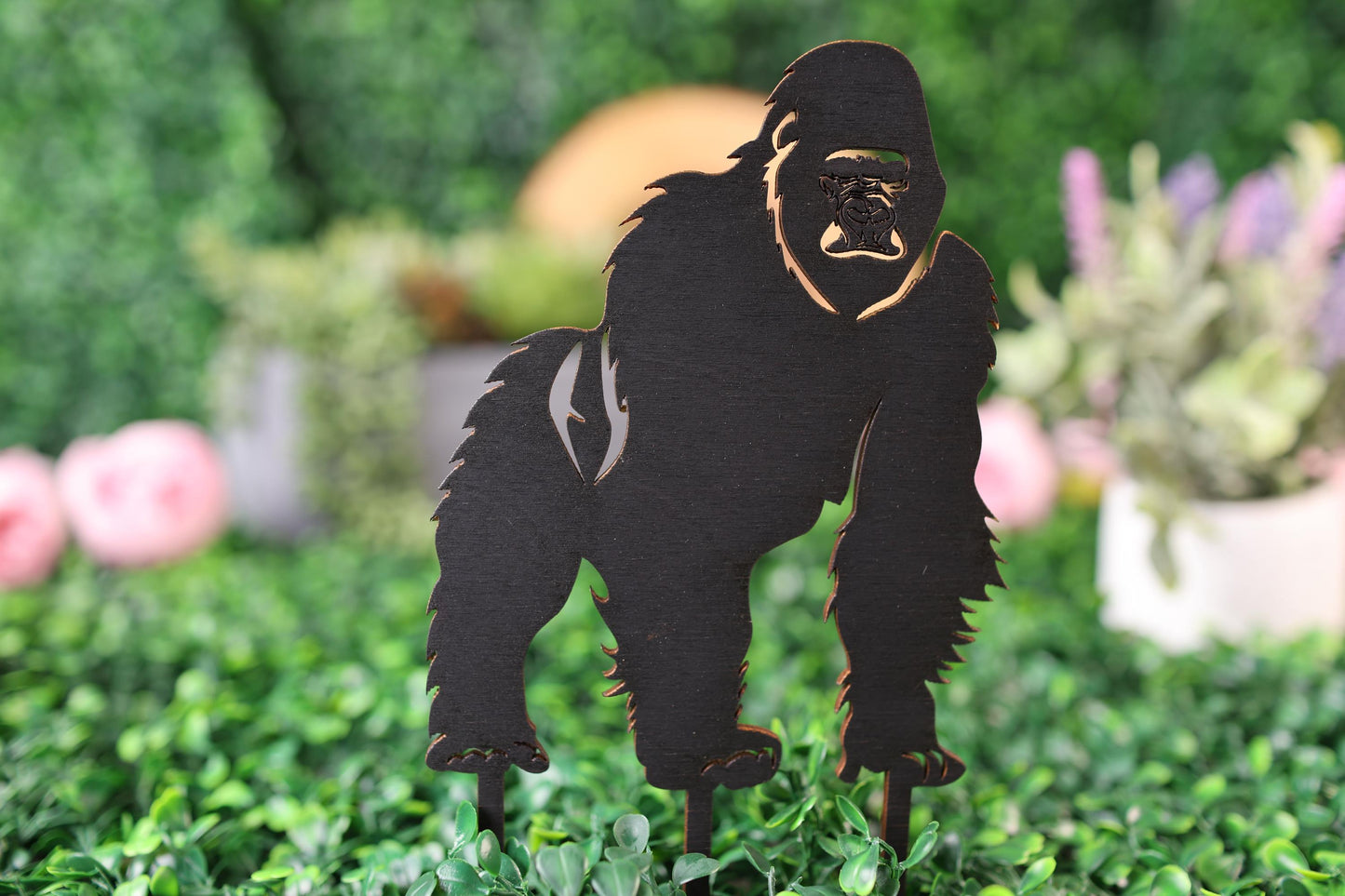 a paper cut out of a gorilla standing in the grass