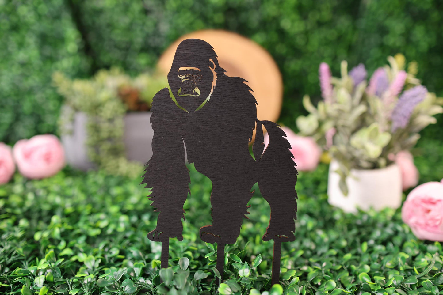 a cut out of a gorilla standing in a field of flowers