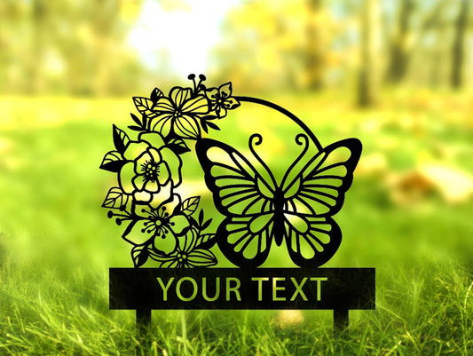 a metal sign with a butterfly and flowers on it