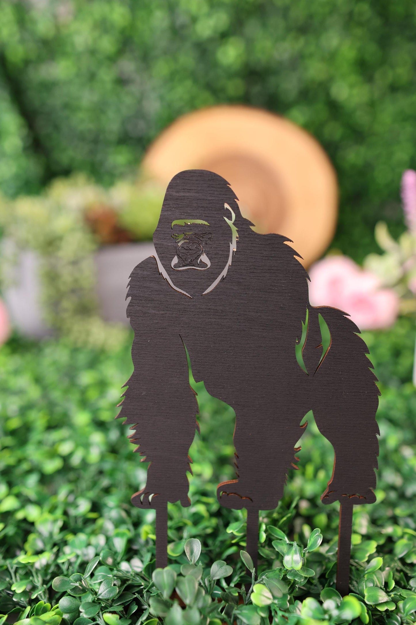 a cut out of a woman&#39;s face on top of a hedge